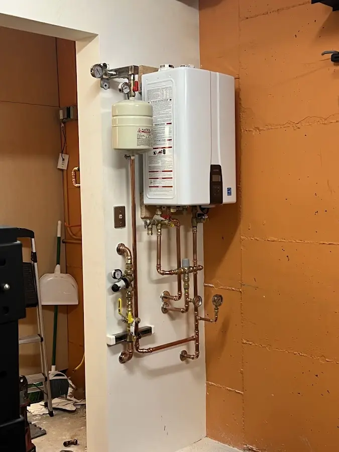 Plumbing technician inspecting water heater connections in Meadow Woods